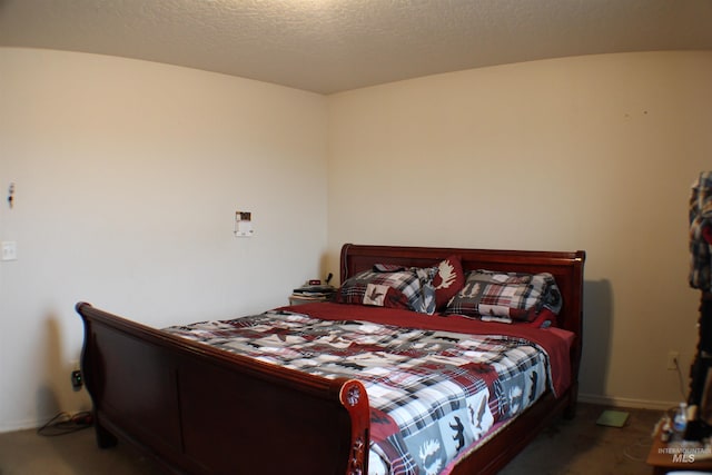 carpeted bedroom with baseboards and a textured ceiling