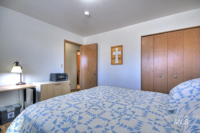 bedroom featuring a textured ceiling and a closet