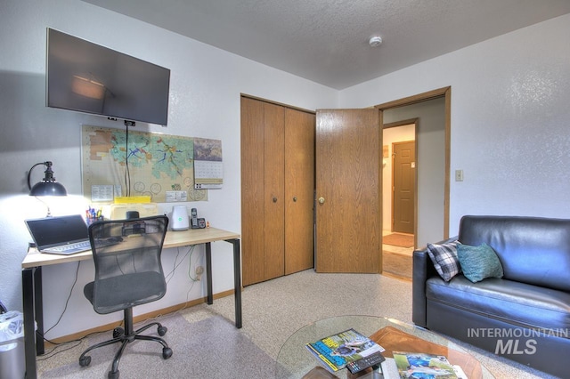home office with baseboards and a textured ceiling
