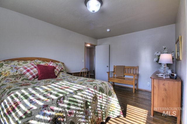 bedroom featuring dark wood finished floors