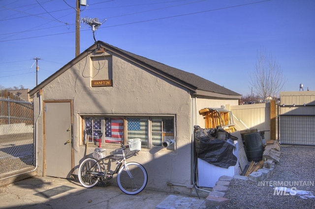 exterior space with fence and stucco siding