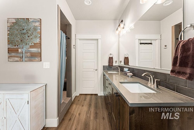 59 S Ravine Way, Nampa, ID 83687 - full bathroom with double vanity, wood finished floors, a shower with curtain, and baseboards