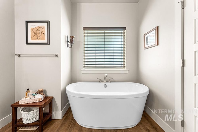 59 S Ravine Way, Nampa, ID 83687 - full bathroom with baseboards, a freestanding tub, and wood finished floors