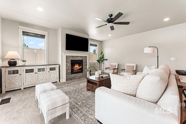 59 S Ravine Way, Nampa, ID 83687 - living area with a ceiling fan, light colored carpet, a stone fireplace, recessed lighting, and a textured ceiling