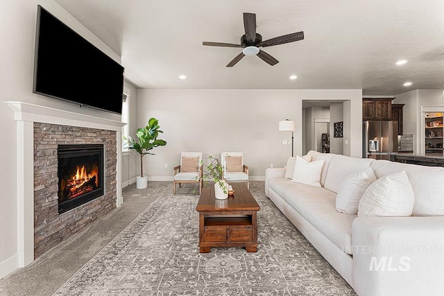 59 S Ravine Way, Nampa, ID 83687 - living room featuring a ceiling fan, recessed lighting, a fireplace, light colored carpet, and baseboards