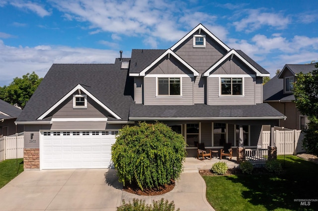 2602 S Groom Way, Meridian, ID 83642 - craftsman-style house featuring driveway, covered porch, an attached garage, stone siding, and roof with shingles