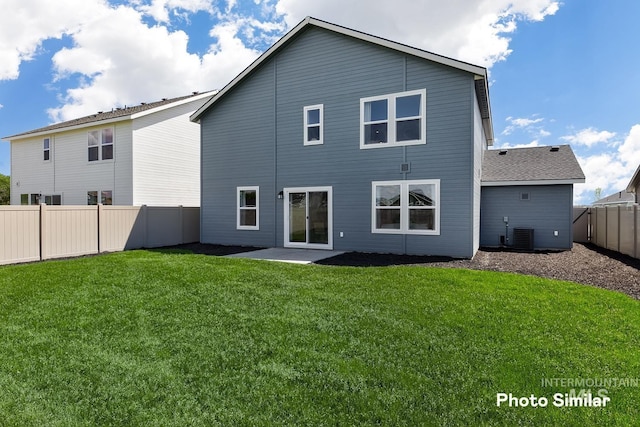 back of house with a fenced backyard, cooling unit, a yard, and a patio