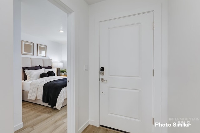 interior space featuring baseboards and light wood-style flooring