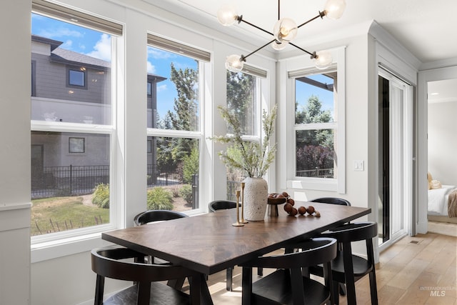 3051 S Sedgebrook Ln, Eagle, ID 83616 - dining room with healthy amount of natural light, light wood-style floors, a chandelier, and crown molding