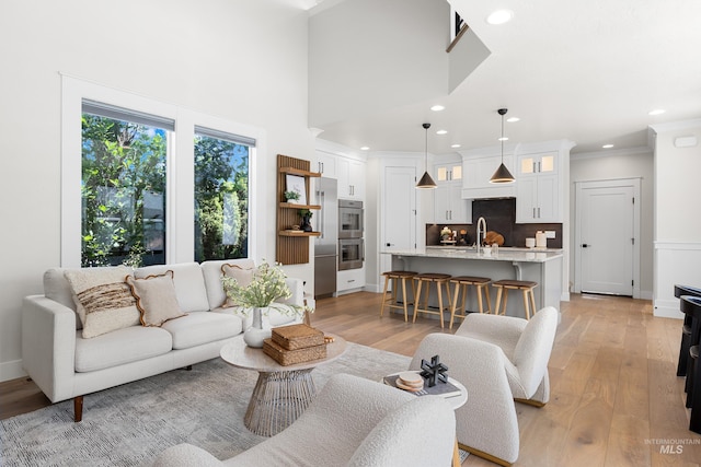 3051 S Sedgebrook Ln, Eagle, ID 83616 - living area featuring light wood-type flooring, recessed lighting, ornamental molding, and a towering ceiling