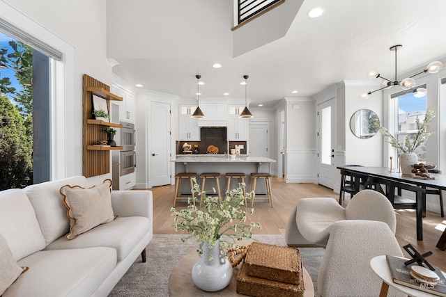3051 S Sedgebrook Ln, Eagle, ID 83616 - living area featuring recessed lighting, light wood-style floors, plenty of natural light, ornamental molding, and a chandelier