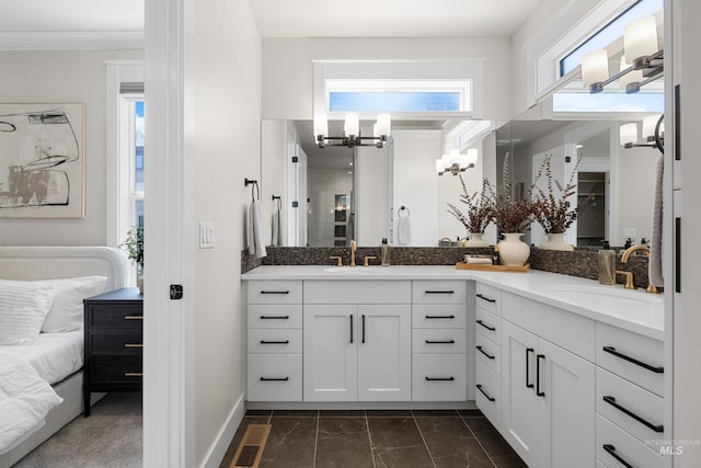 3051 S Sedgebrook Ln, Eagle, ID 83616 - ensuite bathroom featuring a chandelier, double vanity, marble look tile flooring, and baseboards