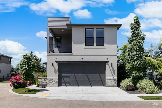 3051 S Sedgebrook Ln, Eagle, ID 83616 - contemporary house featuring stone siding, stucco siding, a garage, concrete driveway, and a balcony