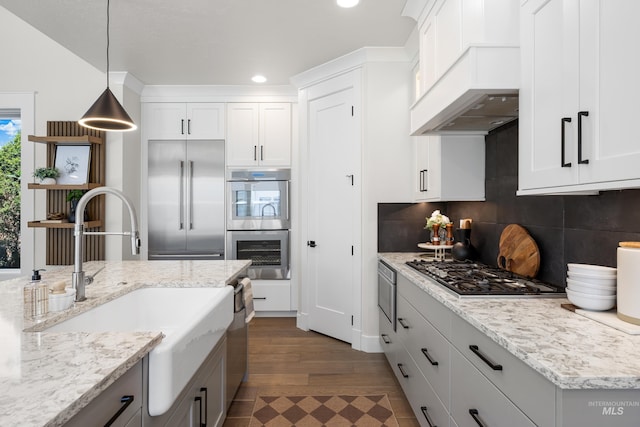 3051 S Sedgebrook Ln, Eagle, ID 83616 - kitchen featuring appliances with stainless steel finishes, premium range hood, a sink, tasteful backsplash, and recessed lighting