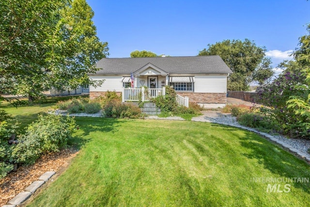 view of front facade with a front lawn and fence