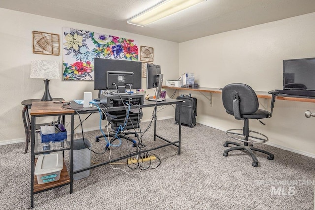 carpeted home office featuring baseboards