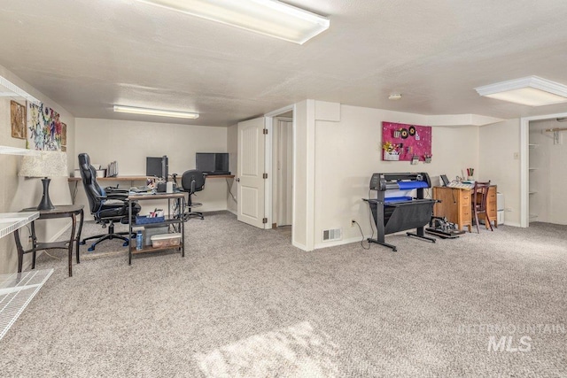 home office with carpet flooring and visible vents