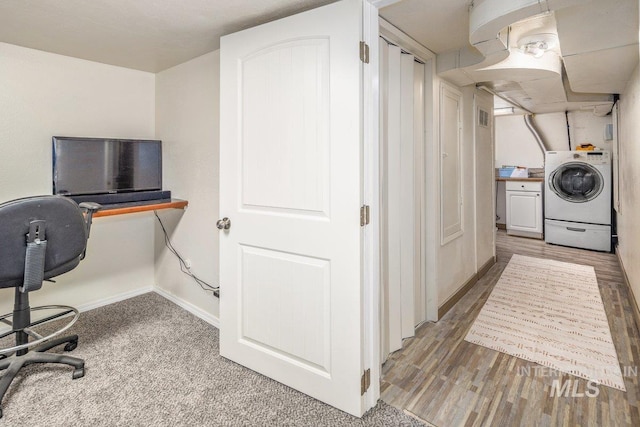 interior space featuring visible vents, baseboards, light wood-style floors, and washer / dryer