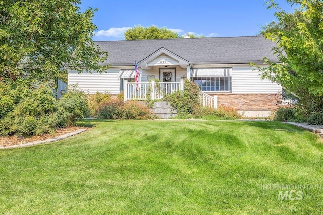 ranch-style house with stone siding and a front yard