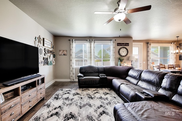 1234 W Sagwon Dr, Kuna, ID 83634 - living room featuring baseboards, ceiling fan, dark wood-type flooring, plenty of natural light, and a textured ceiling