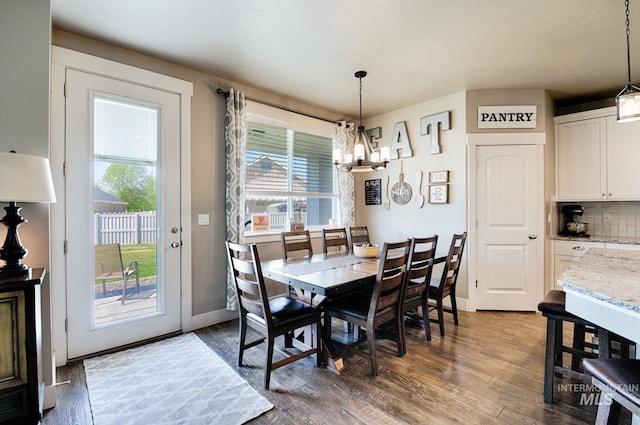 1234 W Sagwon Dr, Kuna, ID 83634 - dining room featuring a chandelier, wood finished floors, and baseboards