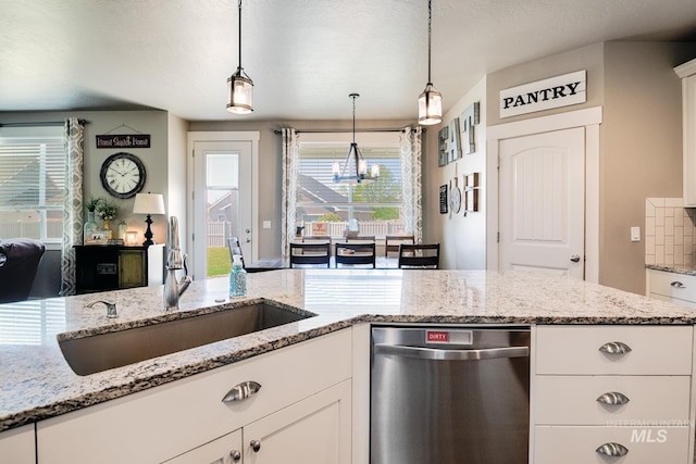 1234 W Sagwon Dr, Kuna, ID 83634 - kitchen with dishwasher, a sink, a chandelier, white cabinetry, and decorative light fixtures