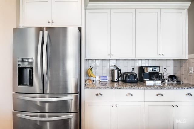 1234 W Sagwon Dr, Kuna, ID 83634 - kitchen featuring stainless steel fridge, light stone counters, white cabinetry, and backsplash
