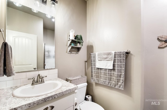 1234 W Sagwon Dr, Kuna, ID 83634 - bathroom with toilet, vanity, and tasteful backsplash