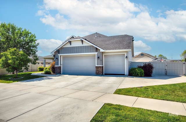 1234 W Sagwon Dr, Kuna, ID 83634 - craftsman house featuring an attached garage, concrete driveway, board and batten siding, and a shingled roof