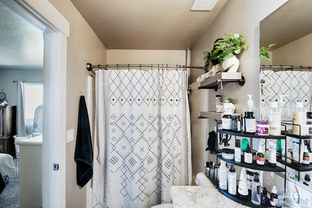 1234 W Sagwon Dr, Kuna, ID 83634 - bathroom with vanity, toilet, and curtained shower