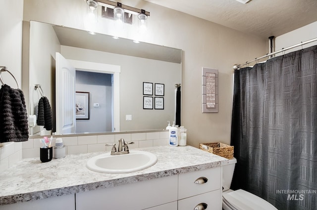 1234 W Sagwon Dr, Kuna, ID 83634 - full bathroom featuring vanity, tasteful backsplash, toilet, and a shower with curtain