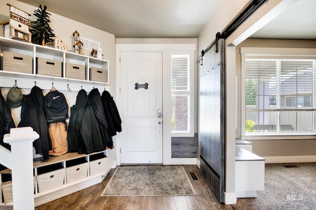 1234 W Sagwon Dr, Kuna, ID 83634 - mudroom with a barn door, baseboards, and wood finished floors