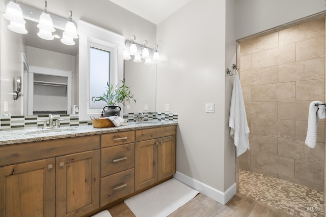 10685 W Evelia St, Boise, ID 83709 - full bathroom with double vanity, walk in shower, backsplash, and wood finished floors