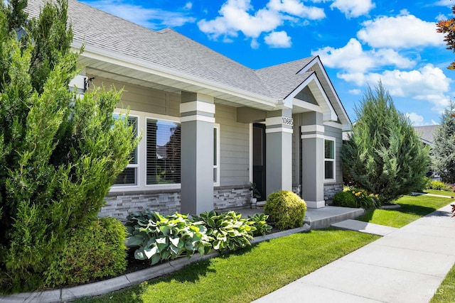 10685 W Evelia St, Boise, ID 83709 - view of front of house with stone siding, a shingled roof, and a front yard