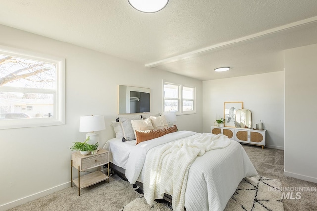 carpeted bedroom featuring a textured ceiling