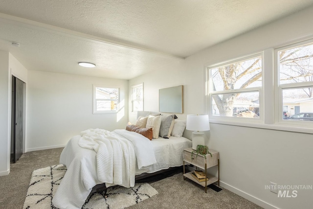 carpeted bedroom with a textured ceiling