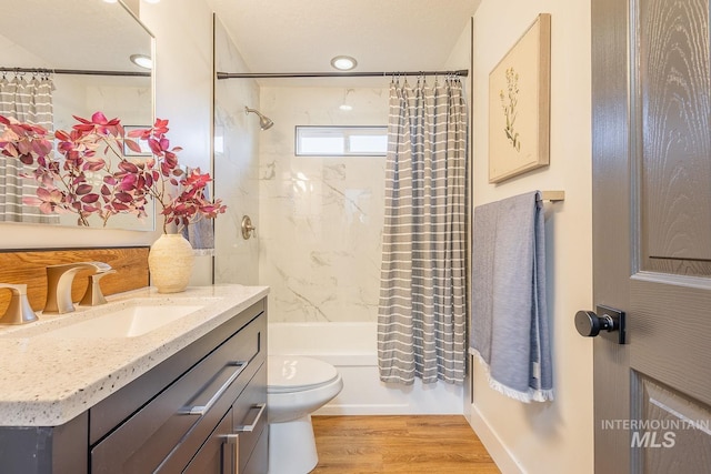 full bathroom with toilet, vanity, shower / tub combo with curtain, and hardwood / wood-style floors