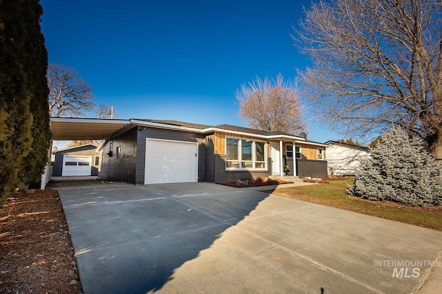 view of front of home with a garage and a carport