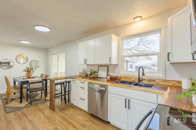 kitchen featuring sink, white cabinetry, and dishwasher