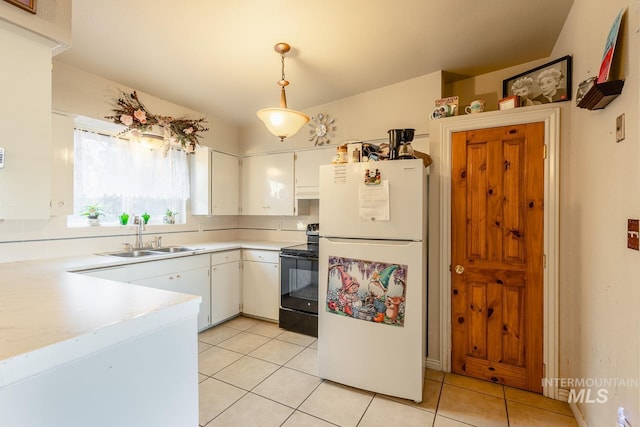 kitchen with sink, hanging light fixtures, black / electric stove, white fridge, and white cabinets