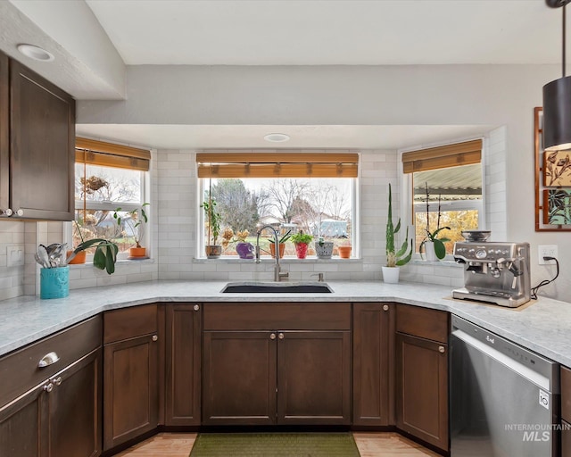 kitchen with a sink, decorative backsplash, dark brown cabinetry, and dishwasher