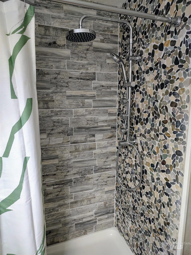 bathroom with a tile shower