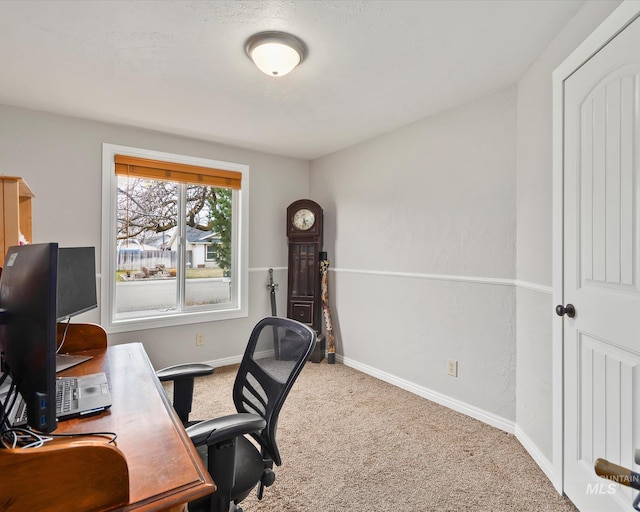 carpeted office space with baseboards