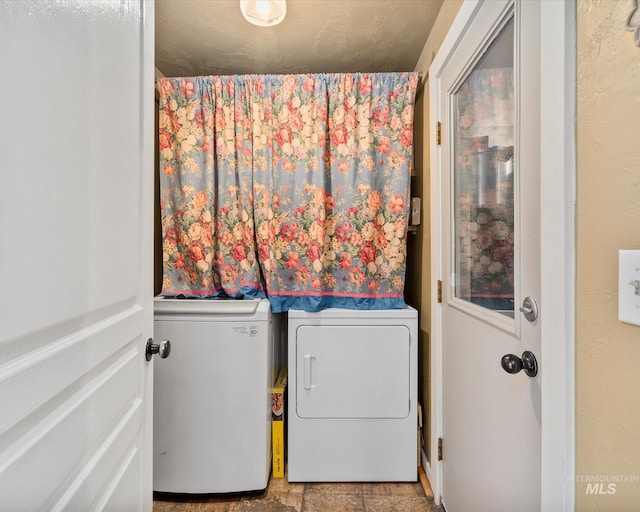 washroom featuring washing machine and dryer and laundry area