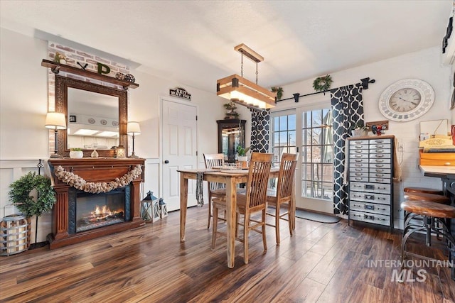 dining area featuring a textured ceiling and dark hardwood / wood-style flooring