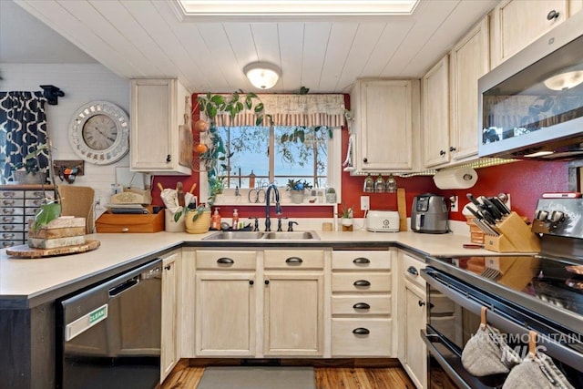 kitchen featuring sink, wooden ceiling, light hardwood / wood-style flooring, and stainless steel appliances