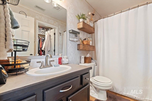 bathroom featuring vanity and toilet