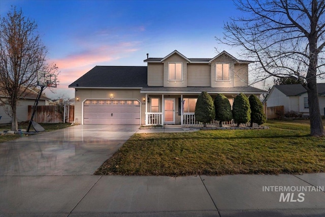 view of front of house featuring a porch, a garage, and a yard