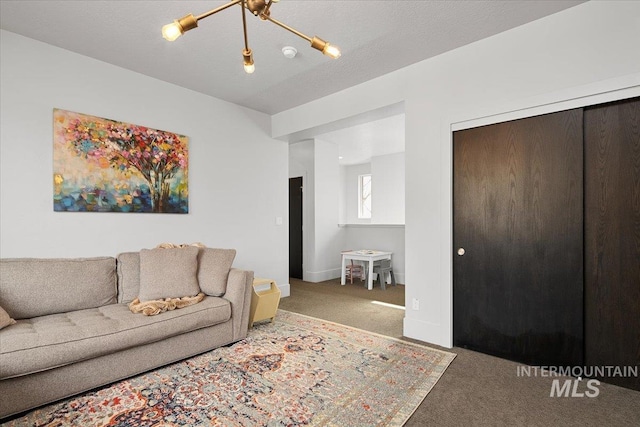 living area featuring a textured ceiling, baseboards, and carpet floors