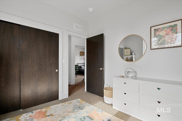 unfurnished bedroom with visible vents and light carpet